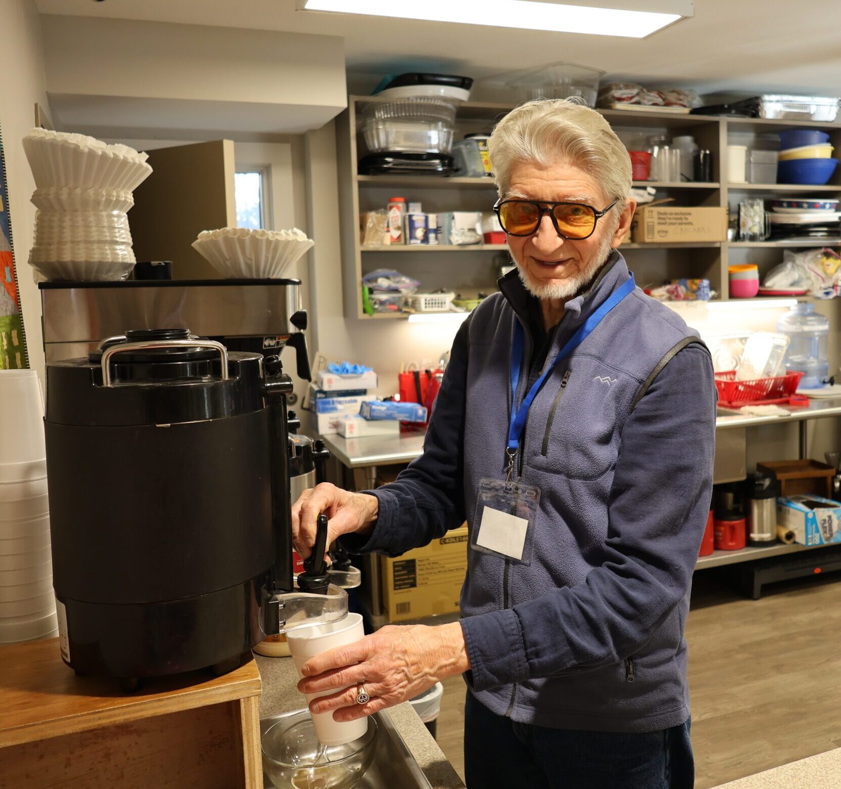 Cup of Hope volunteer pouring a cup of coffee