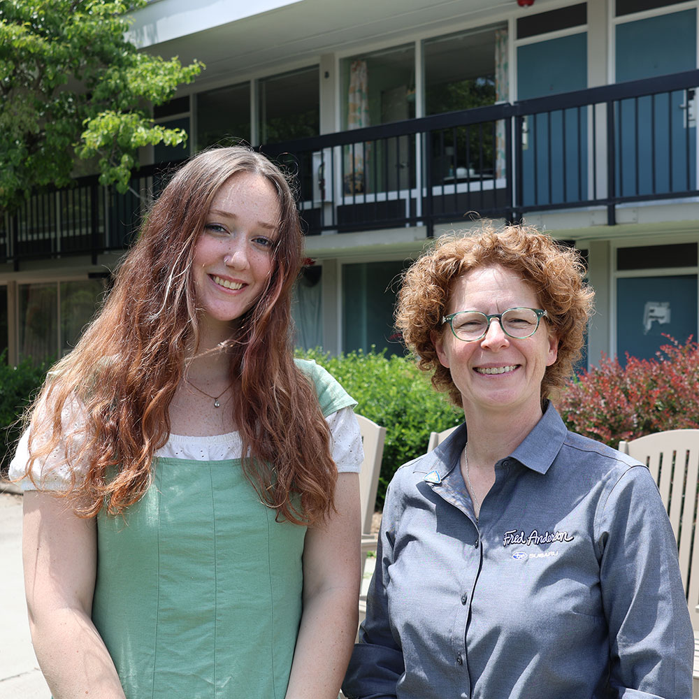 Happy Sponsors with a homeward bound banner at an outdoor event