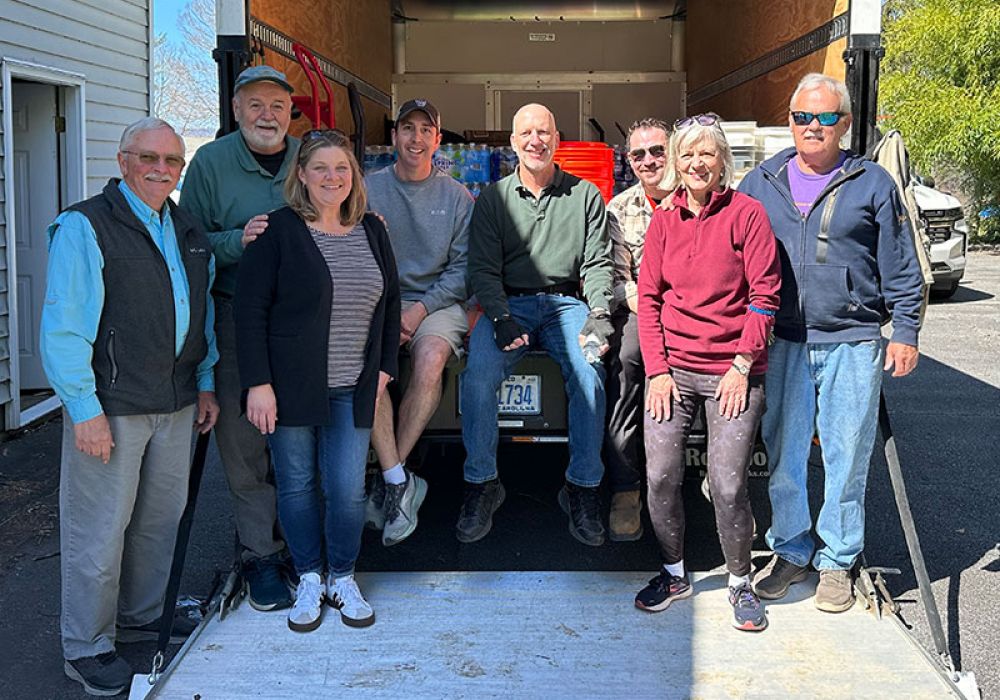 Volunteers standing in pickup/dropoff truck for the Homeward Bound WNC Welcome Center
